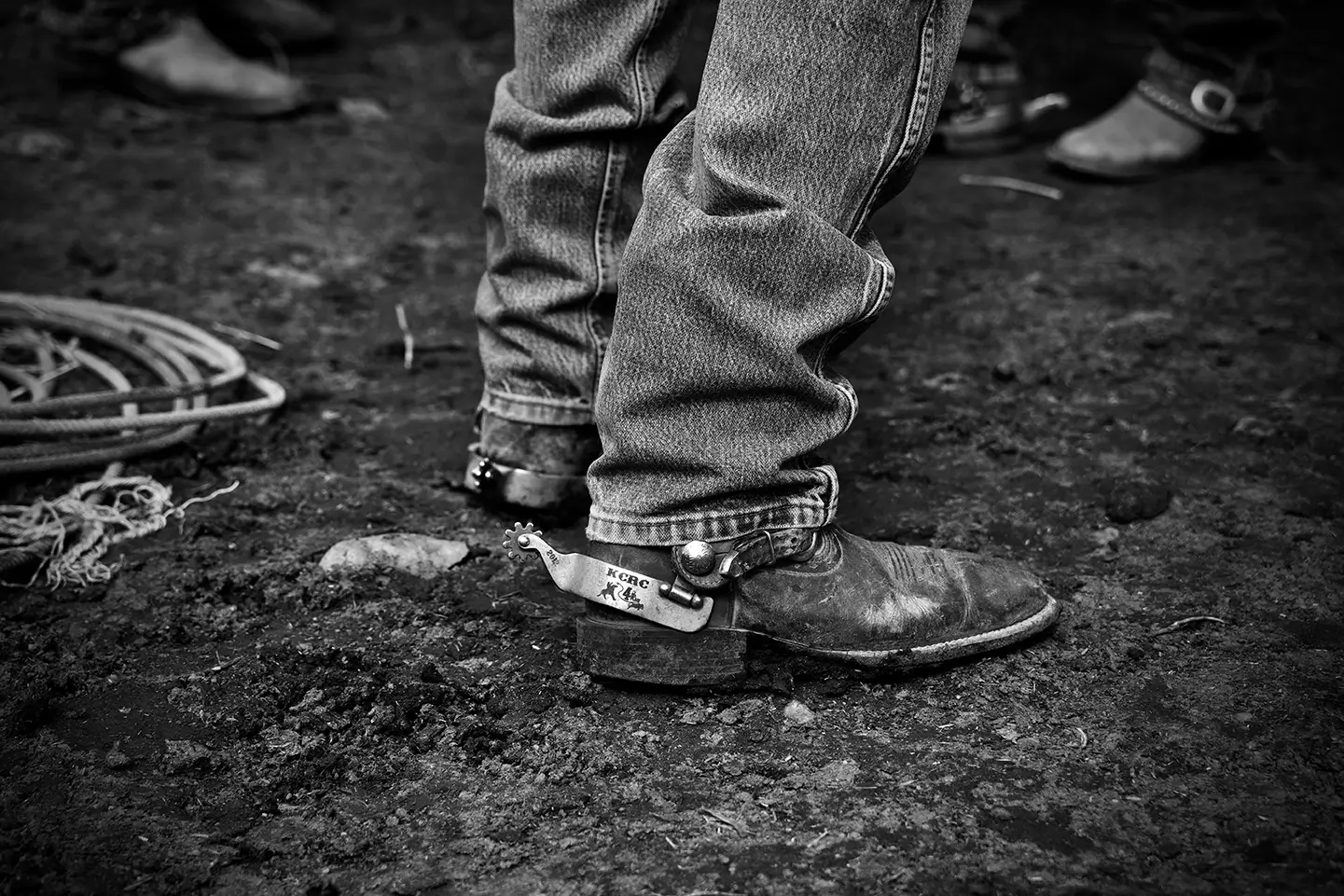 Western ranch competition photograph by Verne Rainey featuring rider's boots & spurs